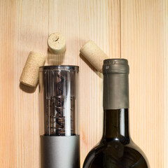 Device for automatic opening of wine bottles, electric corkscrew a light table.