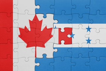 puzzle with the colourful national flag of honduras and flag of canada.