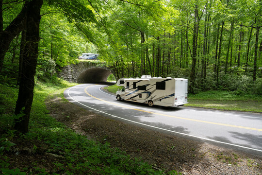 Recreation vehicles driving over and below an overpass along a mountain road through a forest, The Loop, Newfound Gap Road, Great Smoky Mountain National Park, Tennessee