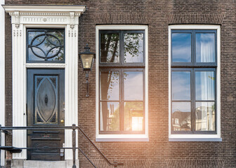 typical century Dutch door holland view in a fortified town with brick houses and front flower gardens. Typical dutch door