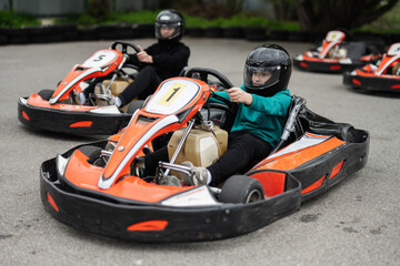 Children Enjoying Go-Kart Racing Outdoors for a Fun and Exciting Adventure