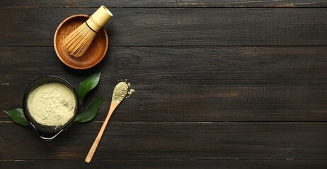 Composition with powdered matcha tea on dark wooden background with space for text, top view
