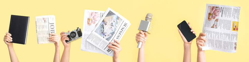 Female hands with microphone, mobile phone and newspaper on color background