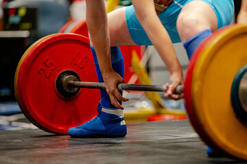 woman athlete deadlift exercise at powerlifting competition