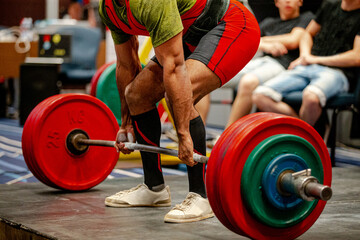 performing deadlift indian athlete in powerlifting competition