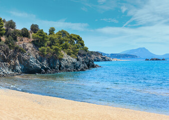 Summer Aegean Sea coast landscape with sandy beach (Sithonia, Halkidiki, Greece). People unrecognizable.