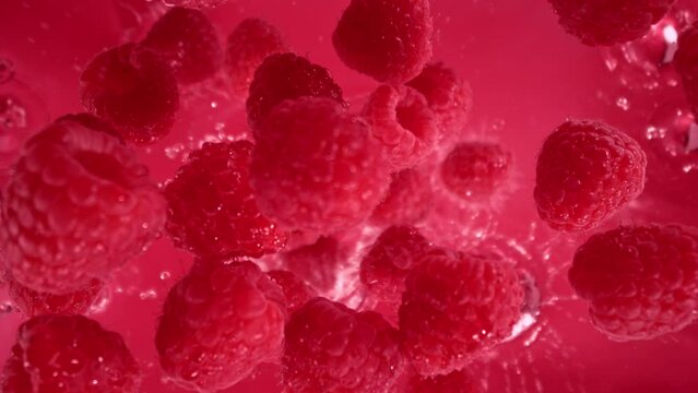 Super Slow Motion Shot of Raspberries Followed by Camera Splashing into Water at 1000 fps.