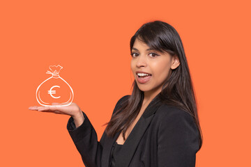 Excited woman presenting bag of euros on palm on orange background	