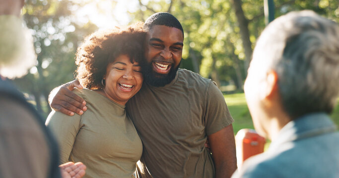 Hug, outdoor and couple with love, sunshine and celebration with joy, romance and relationship in park. People, group and men with women, embrace and summer for fun, cheerful and bonding together