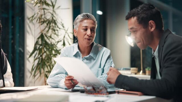 Business people, paperwork and audit discussion in office at night for overtime financial review meeting. Corporate team, accountant and project management with document for erp and budget deadline