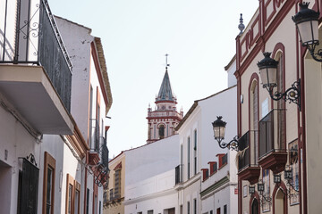 Narrow Street with Historic Buildings and Church Tower