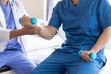 doctor is helping a patient move her muscles after recuperating from a muscle injury and wanting to rehabilitate her to be able to use her normal daily life with continuous physical therapy.