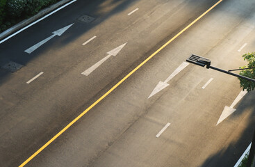 Fototapeta premium Empty asphalt road twin lane aerial view with white traffic arrow symbol.