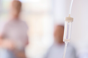 Infusion drip of sick mature couple in bedroom, closeup