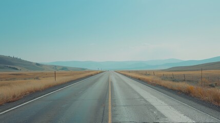 Fototapeta premium An empty, open road stretching into the horizon under a clear sky, the simplicity of the scene evoking a sense of freedom and endless possibility.
