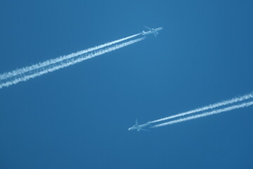 two planes in the sky, two airplane tracks in the blue sky, contrails