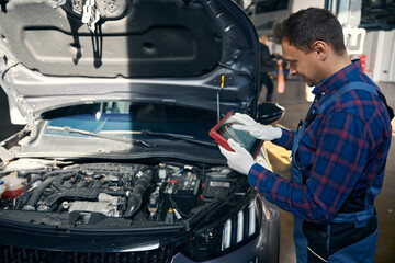 Young employer working with transport in tire fitting