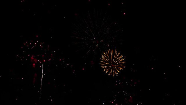 Awesome Real Huge Firework on Deep Black Background Sky on Fireworks festival. Colorful fireworks on 4th of July, Independence day in USA. High quality 4K slow motion video