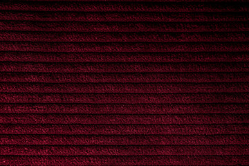 Closeup of red corduroy cloth as patterned textured background
