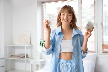 Young woman with menstrual pads in bedroom