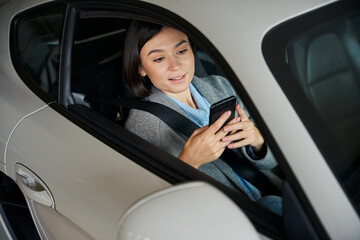 Naklejka premium Pretty passenger waiting for driver in car