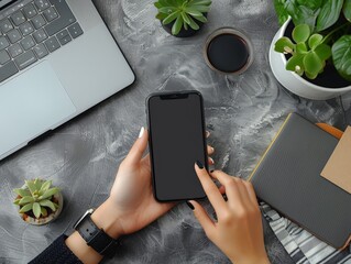 An overhead view of a social media manager scheduling posts for a brand promotion on a smartphone and laptop, set on a minimalist desk. The composition highlights the seamless integration of