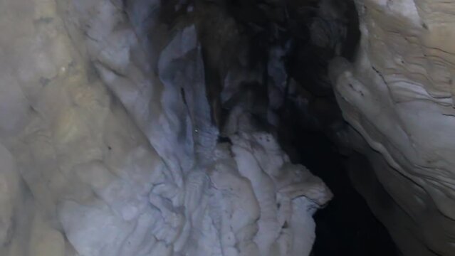 Speleology. Old cave washed by an underground river in the mountain. - Ponor (swallow hole), gypsum cave. Bizarre forms of stalactites and gypsum incrustations (speleothem)