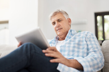 Relax, tablet and mature man on sofa for communication, networking or reading news article in...