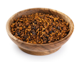 Pieces of chaga mushroom in wooden bowl isolated on white background. With clipping path.