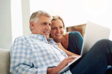 Couple, people and home with laptop on sofa with internet for online or digital application for...
