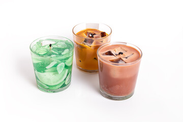 Trendy gel candles in glass cups. Candles in the form of drinks. Mojito and iced coffee. Three candles