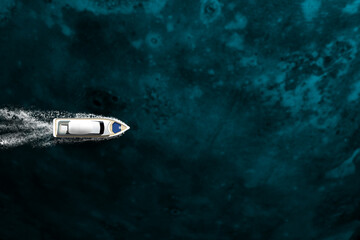 An expensive yacht sails on the ocean, top view
