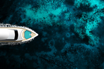 An expensive yacht sails on the ocean, top view