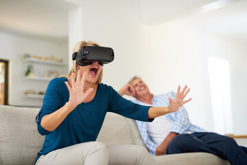 Couple, home and people with vr for games on sofa for online video challenge and fun. Metaverse...