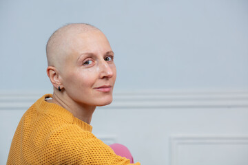 Smiling woman without hair, inspiring courage to fight cancer