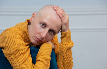 Deep in thoughts, a sad woman struggling with cancer disease
