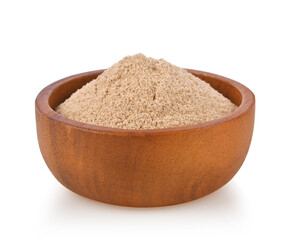 Finely ground white pepper in wood bowl isolated on white.