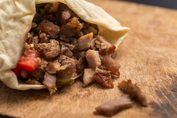 Doner Kebab Gyros Shawarma beef or chiken roll in pitta bread Wrap sandwich on wooden background