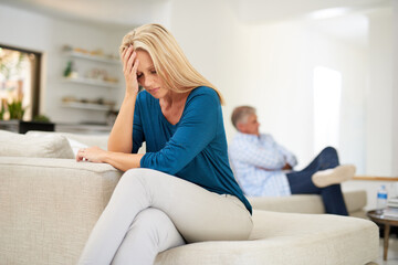 Obraz premium Couch, couple and fight in home for annoyed, divorce or married people for argument. Disagreement, sofa and lounge for frustrated woman, affair or emotion in toxic relationship with mature partner