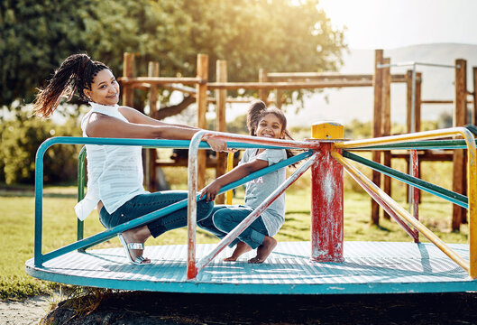 Mother, child and carousel with playground, bonding and love for summer break and play together. Woman, daughter and park equipment for joy, fun and happy girl smile with countryside merry go round