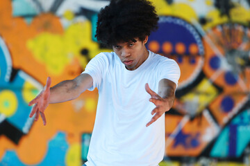 young urban african american man dancing in the street