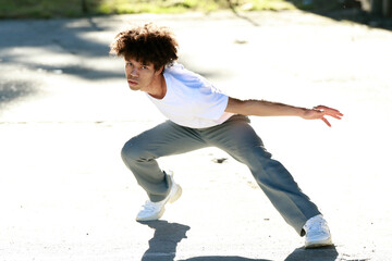 young urban african american man dancing in the street