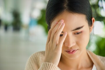 Young asian woman having headache, dizziness, vertigo, stress, mental sickness concept image