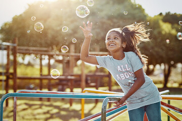 Soap, bubbles and girl with playground, fun and love for summer break and play. Kid, childhood and...
