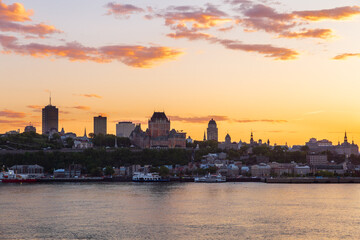 Fototapeta premium The Quebec City skyline seen at sunset from Lévis, with the St. Lawrence River in the foreground, Quebec, Canada