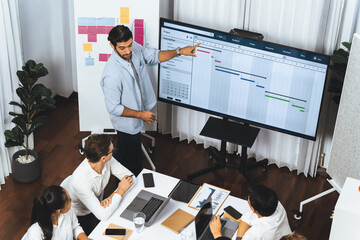 Project manager communicate and collaborate with team using project management software display on...
