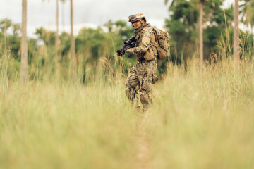 With M16 rifles in hand, soldiers patrol the dangerous jungle battlefield, surrounded by grasslands, ready to fire and defend the territory from enemy attacks coming from all directions