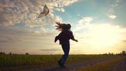 child girl run with a kite in the park. happy family freedom a kid dream concept. child daughter...