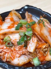 Korean food kimchi in a black bowl