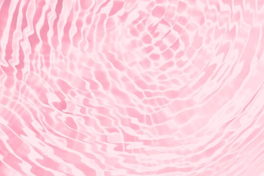 Rippling pink water surface with circles, drops and waves perfect for web banners. pink abstract background